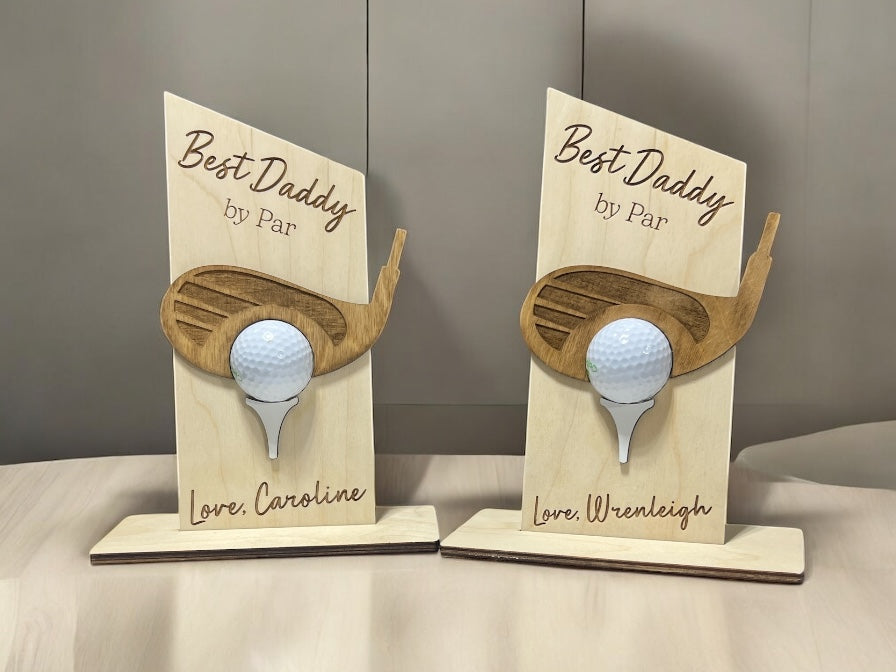 Two wooden golf-themed decorative items with golf tees on a neutral background