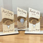 Three wooden plaques with golf-themed designs on a wooden surface.