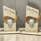 Two wooden golf-themed decorative items with golf tees on a neutral background